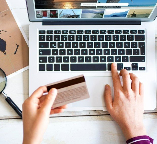 Person booking holiday on laptop