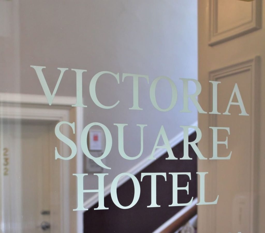 Reception sign on glass at the Victoria Square Hotel