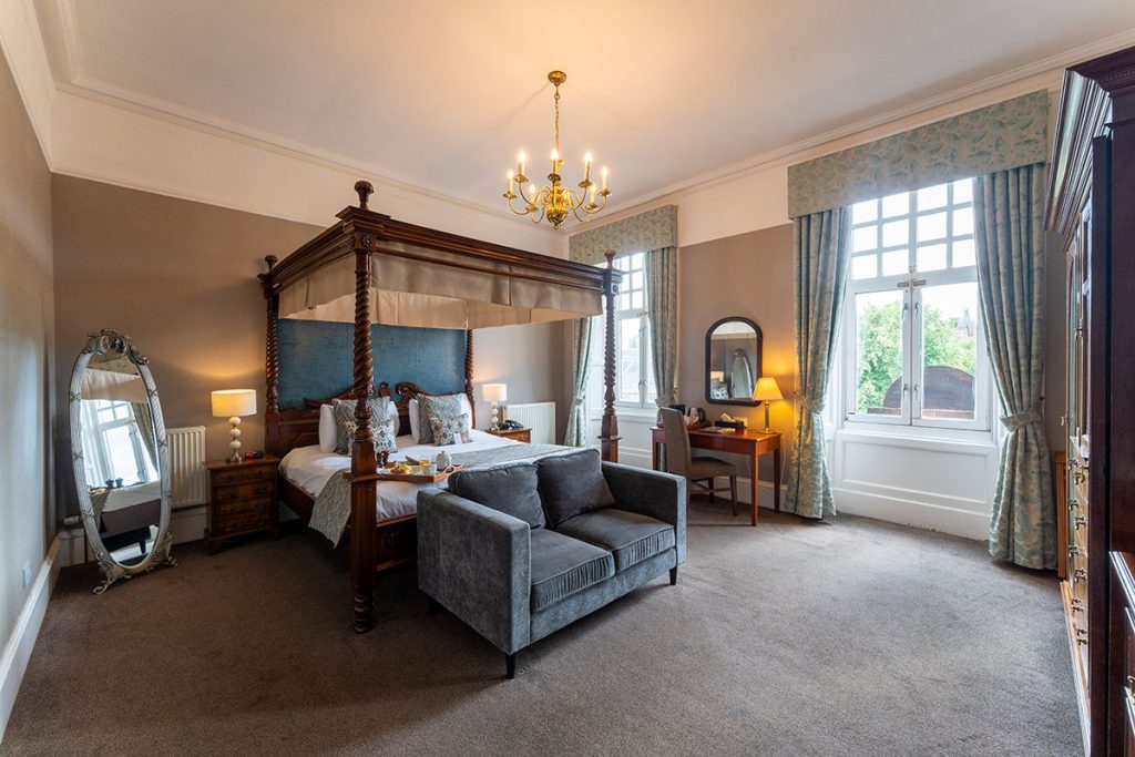 Four poster bed in large bedroom at Sherbrooke Castle